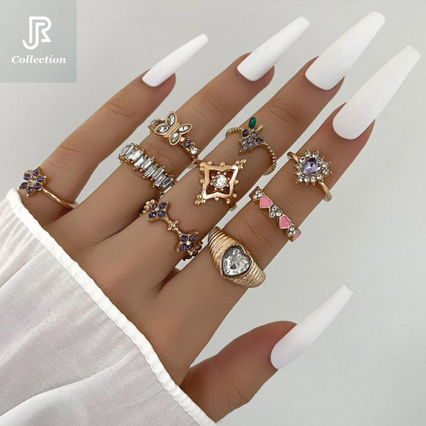hand wearing stacked geometric constellation rings with crystals